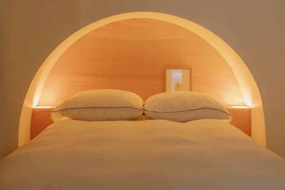 Modern bedroom featuring stylish lamps and contemporary decor - Babylon Stays